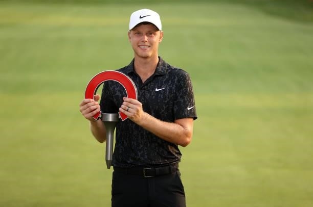 Cam Davis of Australia poses with the trophy after winning on the fifth sudden death playoff hole against Troy Merritt during the final round of the...