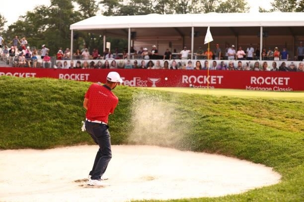 Troy Merritt plays his shot from the 15th bunker during the second sudden death playoff hole during the final round of the Rocket Mortgage Classic on...