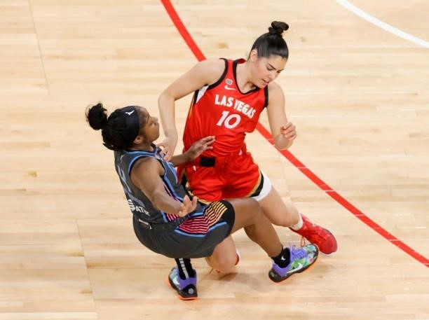 Kelsey Plum of the Las Vegas Aces and Aari McDonald of the Atlanta Dream fall to the floor after colliding during their game at Michelob ULTRA Arena...