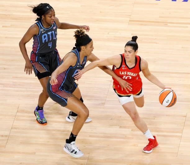 Kelsey Plum of the Las Vegas Aces is guarded by Tianna Hawkins and Aari McDonald of the Atlanta Dream during their game at Michelob ULTRA Arena on...