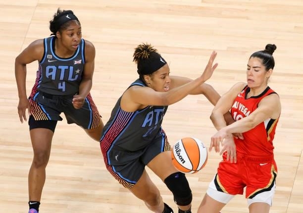 Kelsey Plum of the Las Vegas Aces under pressure from Tianna Hawkins and Aari McDonald of the Atlanta Dream during their game at Michelob ULTRA Arena...