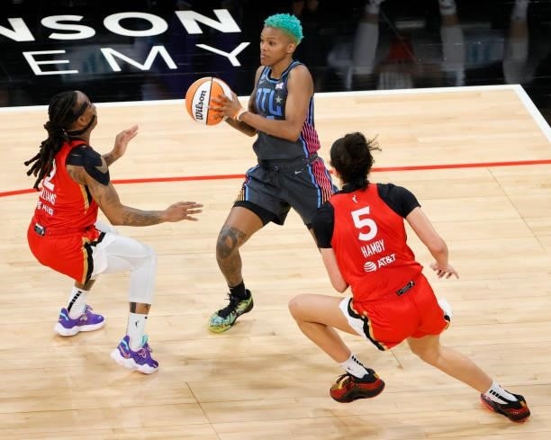 Courtney Williams of the Atlanta Dream looks to pass against Riquna Williams and Dearica Hamby of the Las Vegas Aces during their game at Michelob...