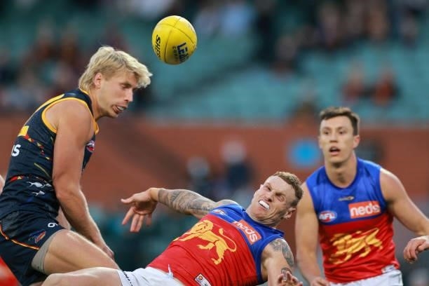 Billy Frampton of the Crows and Mitch Robinson of the Lions compete for the ball during the round 16 AFL match between Adelaide Crows and Brisbane...