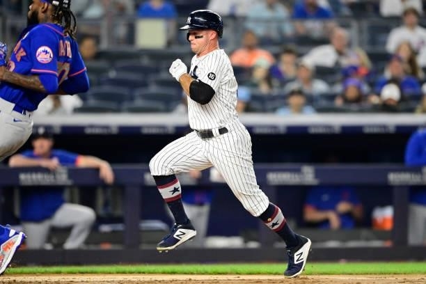 Brett Gardner of the New York Yankees runs home to score a run on a wild-pitch against the New York Mets in the fifth inning of game two of a...