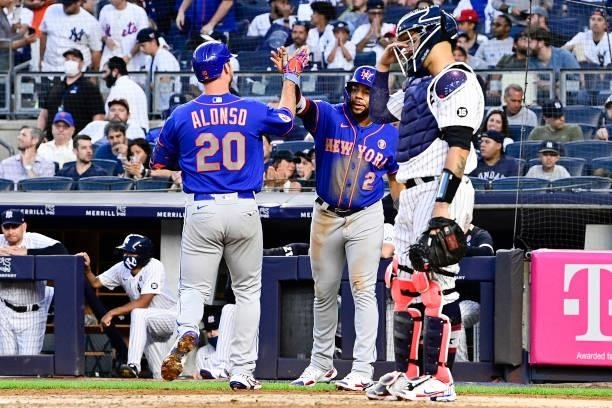 Pete Alonso of the New York Mets is congratulated by Dominic Smith after hitting a two-run home run against the New York Yankees in the fourth inning...