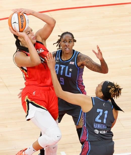 Liz Cambage of the Las Vegas Aces is fouled by Tianna Hawkins of the Atlanta Dream as Crystal Bradford of the Dream defends during their game at...