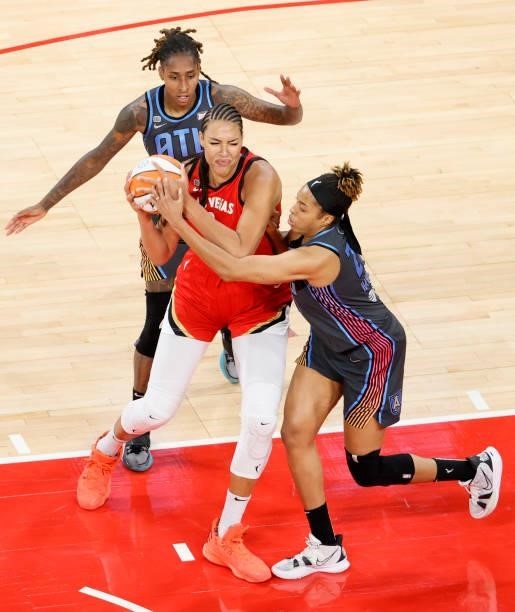 Liz Cambage of the Las Vegas Aces is fouled by Tianna Hawkins of the Atlanta Dream as Crystal Bradford of the Dream defends during their game at...
