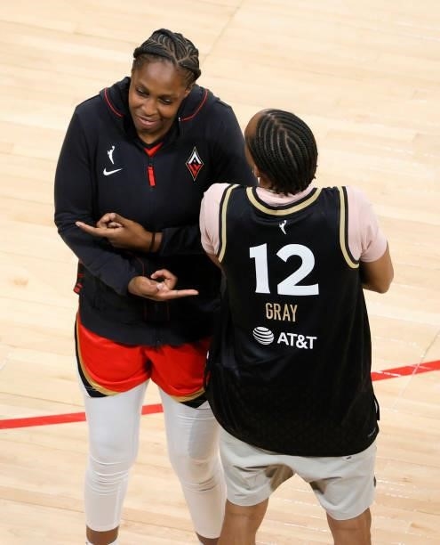 Chelsea Gray of the Las Vegas Aces poses with a fan courtside after the team's 118-95 victory over the Atlanta Dream at Michelob ULTRA Arena on July...