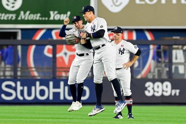 Tim Locastro, Aaron Judge and Brett Gardner of the New York Yankees celebrate the team's win against the New York Mets during game two of a...