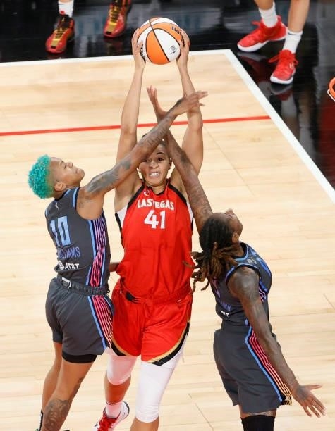 Courtney Williams of the Atlanta Dream fouls Kiah Stokes of the Las Vegas Aces as she grabs a rebound against Williams and Crystal Bradford during...