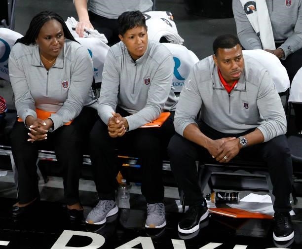 Assistant coaches Daynia La-Force, La’Keshia Frett and Darius Taylor of the Atlanta Dream look on from the bench during a game against the Las Vegas...