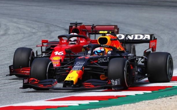 Sergio Perez of Mexico driving the Red Bull Racing RB16B Honda leads Charles Leclerc of Monaco driving the Scuderia Ferrari SF21 during the F1 Grand...