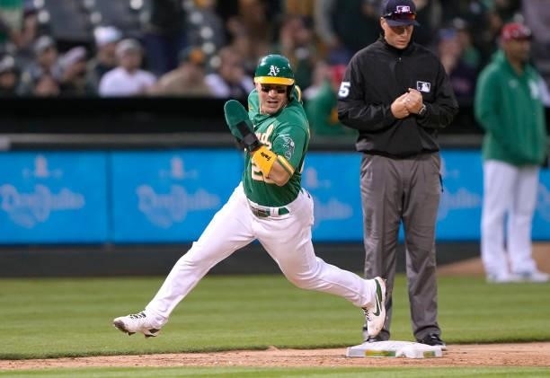 Ramon Laureano of the Oakland Athletics rounds third base to score against the Boston Red Sox in the bottom of the 12th inning at RingCentral...