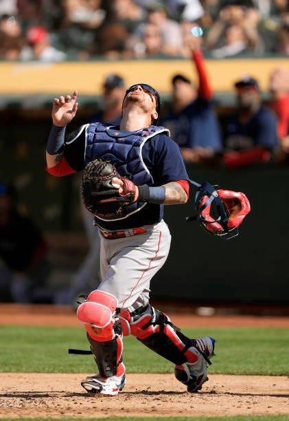 Christian Vazquez of the Boston Red Sox tracks a foul pop-up off the bat of Frank Schwindel of the Oakland Athletics in the bottom of the second...