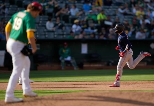 Enrique Hernandez of the Boston Red Sox trots around the bases after hitting a solo home run off of Cole Irvin of the Oakland Athletics in the top of...