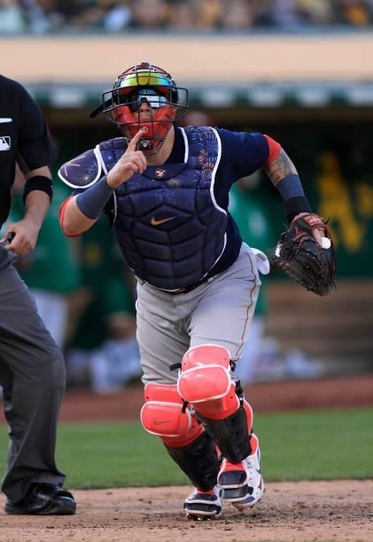 Christian Vazquez of the Boston Red Sox chases after a foul pop-up against the Oakland Athletics in the bottom of the seventh inning at RingCentral...