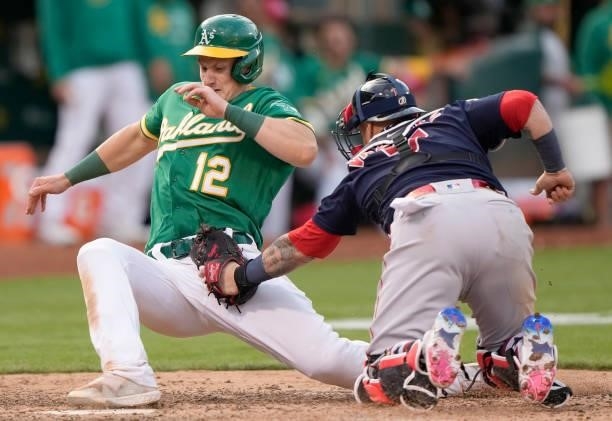 Christian Vazquez of the Boston Red Sox at home plate tags out Sean Murphy of the Oakland Athletics in the bottom of the tenth inning at RingCentral...