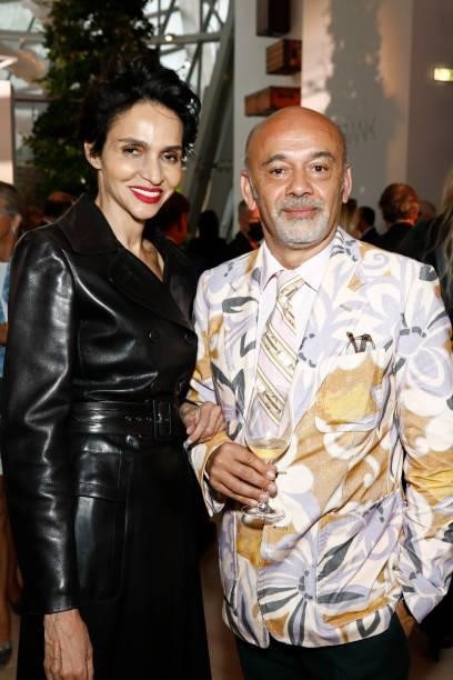 Farida Khelfa and Christian Louboutin attend the Louis Vuitton Parfum Dinner at Fondation Louis Vuitton on July 05, 2021 in Paris, France.