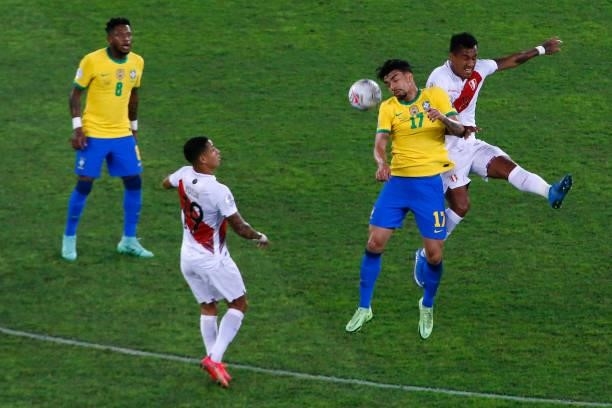 Lucas Paqueta of Brazil jumps for the ball with Renato Tapia of Peru during a semi-final match of Copa America Brazil 2021 between Brazil and Peru at...