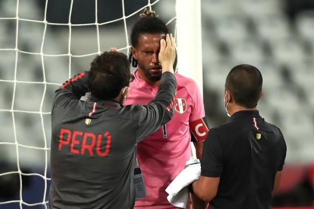 Pedro Gallese goalkeeper of Peru receives medical attention during a semi-final match of Copa America Brazil 2021 between Brazil and Peru at Estadio...