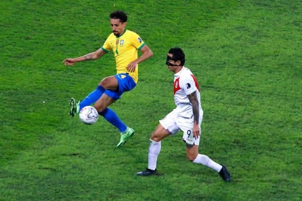 Marquinhos of Brazil competes for the ball with Gianluca Lapadula of Peru during a semi-final match of Copa America Brazil 2021 between Brazil and...