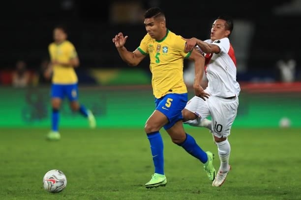 Casemiro of Brazil competes for the ball with Christian Cueva of Peru during a semi-final match of Copa America Brazil 2021 between Brazil and Peru...
