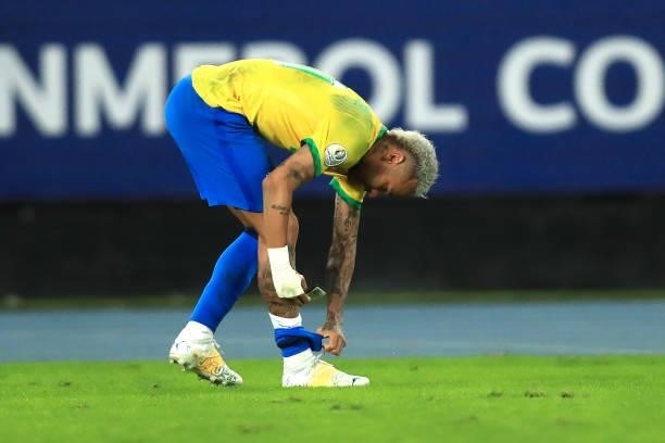 Neymar Jr. Of Brazil adjusts his shin guard during a semi-final match of Copa America Brazil 2021 between Brazil and Peru at Estadio Olímpico Nilton...