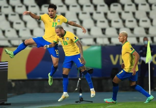 Lucas Paqueta of Brazil celebrates with teammates Neymar Jr. And Richarlison after scoring the first goal of his team during a semi-final match of...