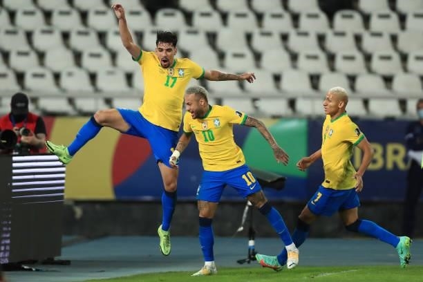 Lucas Paqueta of Brazil celebrates with teammates Neymar Jr. And Richarlison after scoring the first goal of his team during a semi-final match of...