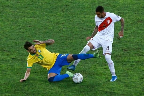 Lucas Paqueta of Brazil competes for the ball with Sergio Peña of Peru during a semi-final match of Copa America Brazil 2021 between Brazil and Peru...