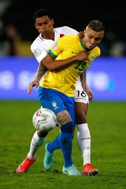 Everton of Brazil competes for the ball with Marcos López of Peru during a semi-final match of Copa America Brazil 2021 between Brazil and Peru at...