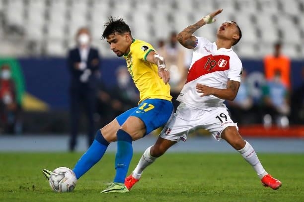Lucas Paqueta of Brazil competes for the ball with Yoshimar Yotún of Peru during a semi-final match of Copa America Brazil 2021 between Brazil and...