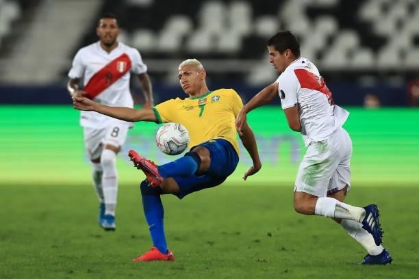 Richarlison of Brazil competes for the ball with Aldo Corzo of Peru during a semi-final match of Copa America Brazil 2021 between Brazil and Peru at...