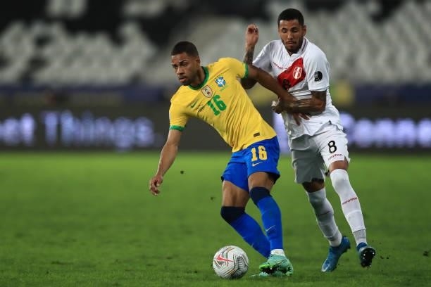 Renan Lodi of Brazil competes for the ball with Sergio Peña of Peru during a semi-final match of Copa America Brazil 2021 between Brazil and Peru at...
