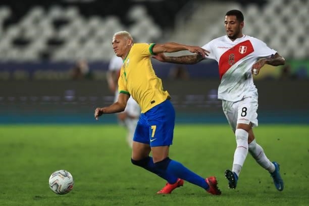 Richarlison of Brazil competes for the ball with Sergio Peña of Peru during a semi-final match of Copa America Brazil 2021 between Brazil and Peru at...