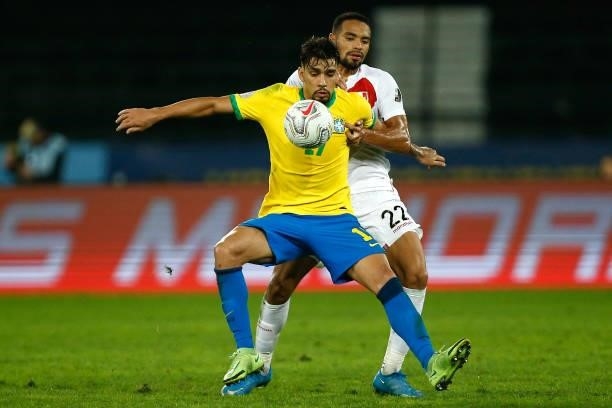 Lucas Paqueta of Brazil competes for the ball with Alexander Callens of Peru during a semi-final match of Copa America Brazil 2021 between Brazil and...
