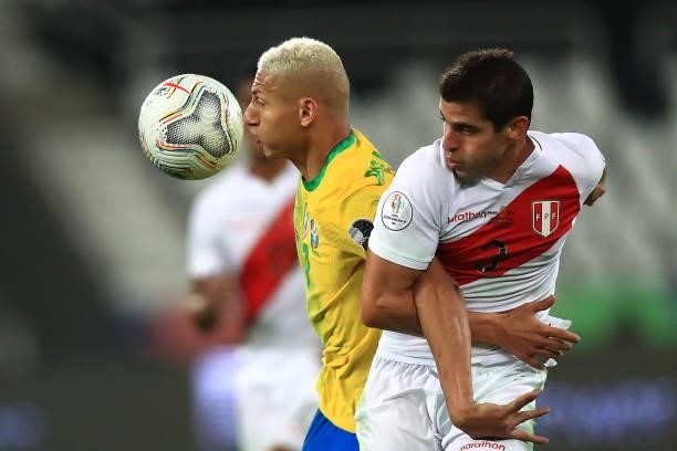 Richarlison of Brazil competes for the ball with Aldo Corzo of Peru during a semi-final match of Copa America Brazil 2021 between Brazil and Peru at...