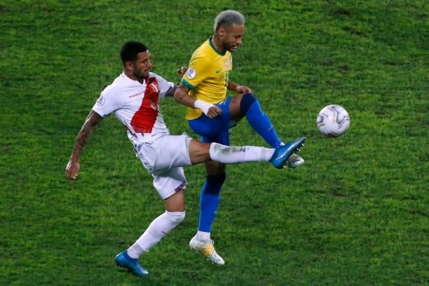 Sergio Peña of Peru competes for the ball with Neymar Jr. Of Brazil during a semi-final match of Copa America Brazil 2021 between Brazil and Peru at...