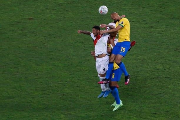 Fabinho of Brazil jumps for the ball with Sergio Peña of Peru during a semi-final match of Copa America Brazil 2021 between Brazil and Peru at...