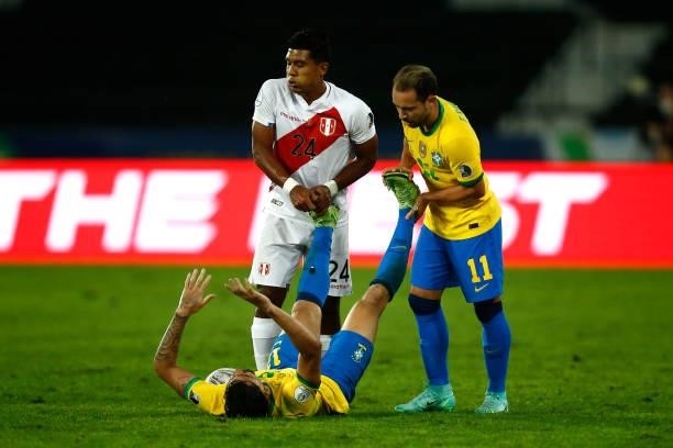 Lucas Paqueta of Brazil receives help from his teammate Everton Ribeiro and Raziel García of Peru during a semi-final match of Copa America Brazil...