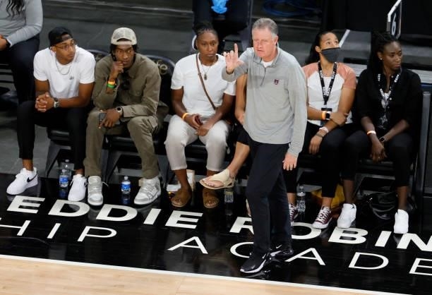 Fans sit behind interim head coach Mike Petersen of the Atlanta Dream as he signals his players during their game against the Las Vegas Aces at...