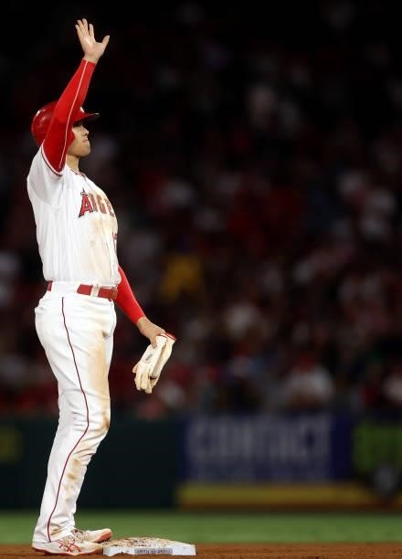 Shohei Ohtani of the Los Angeles Angels waves after advancing to second base against the Boston Red Sox in the fifth inning at Angel Stadium of...