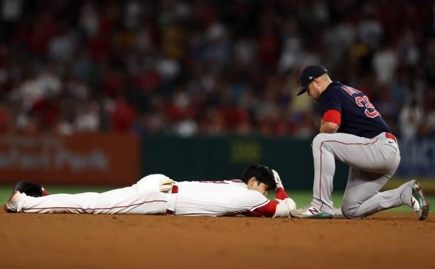 Shohei Ohtani of the Los Angeles Angels is safe against Christian Arroyo of the Boston Red Sox in the fifth inning at Angel Stadium of Anaheim on...