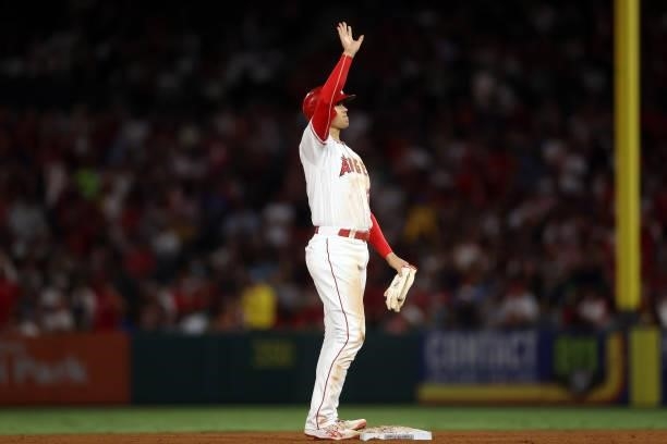Shohei Ohtani of the Los Angeles Angels waves after advancing to second base against the Boston Red Sox in the fifth inning at Angel Stadium of...