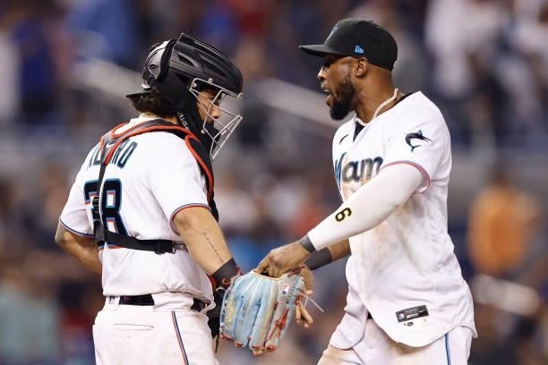 Jorge Alfaro and Starling Marte of the Miami Marlins celebrate after defeating the Los Angeles Dodgers 5-4 at loanDepot park on July 05, 2021 in...