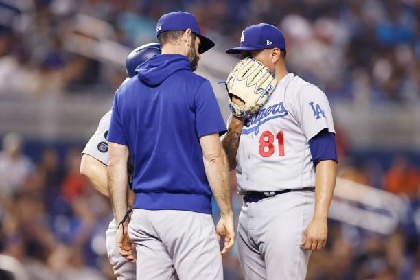 Victor Gonzalez of the Los Angeles Dodgers talks with pitching coach Mark Prior against the Miami Marlins at loanDepot park on July 05, 2021 in...