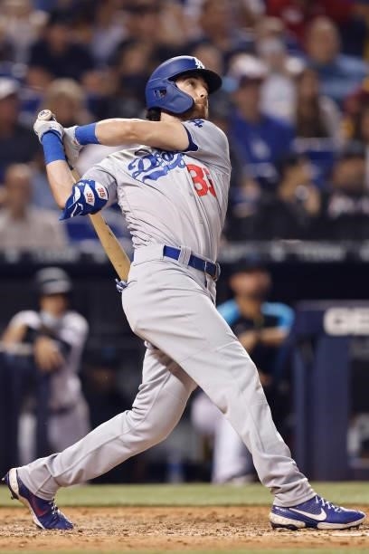 Cody Bellinger of the Los Angeles Dodgers hits a RBI sacrifice fly during the eighth inning against the Miami Marlins at loanDepot park on July 05,...