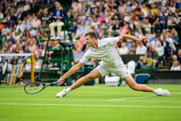 Hubert Hurkacz of Poland hits a backhand against Daniil Medvedev of Russia in the fourth round of the gentlemen's singles during Day Eight of The...