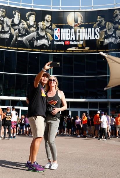Phoenix Suns fans take a selfie with the NBA Finals signage before Game One of the NBA Finals between the Milwaukee Bucks and the Phoenix Suns at...