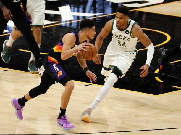 Devin Booker of the Phoenix Suns drives against Giannis Antetokounmpo of the Milwaukee Bucks during the first quarter in Game One of the NBA Finals...